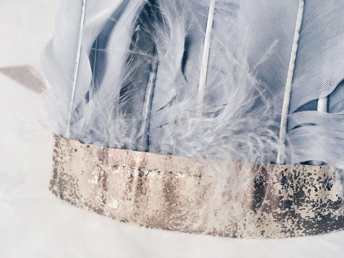 close up of Grey feather and distressed metallic leather headdress by For Just ONE Day