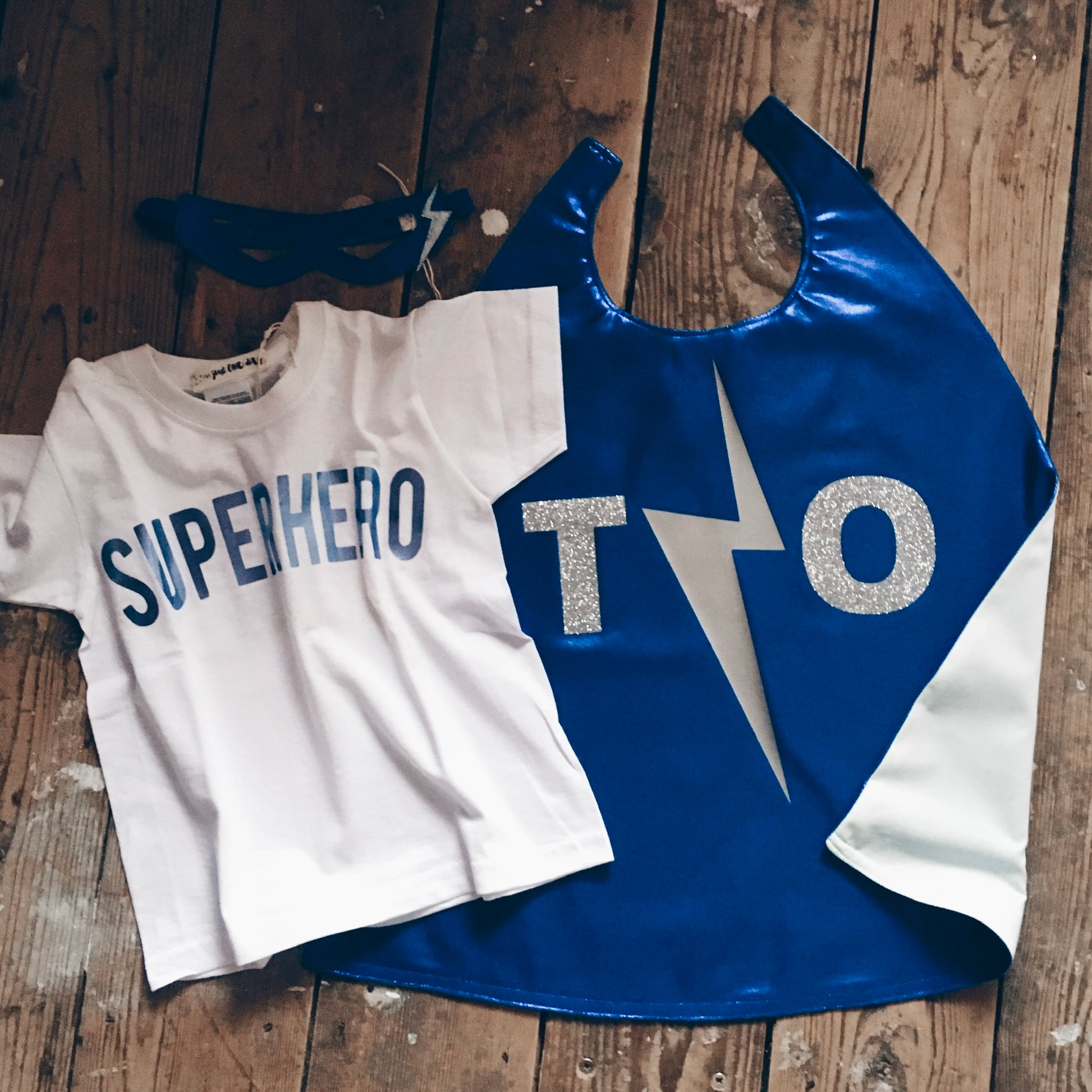 Flat lay of sapphire Blue, metallic superhero costume by For Just ONE Day