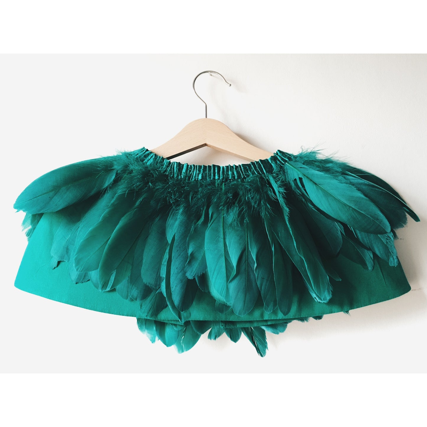 back view of emerald green feather cape