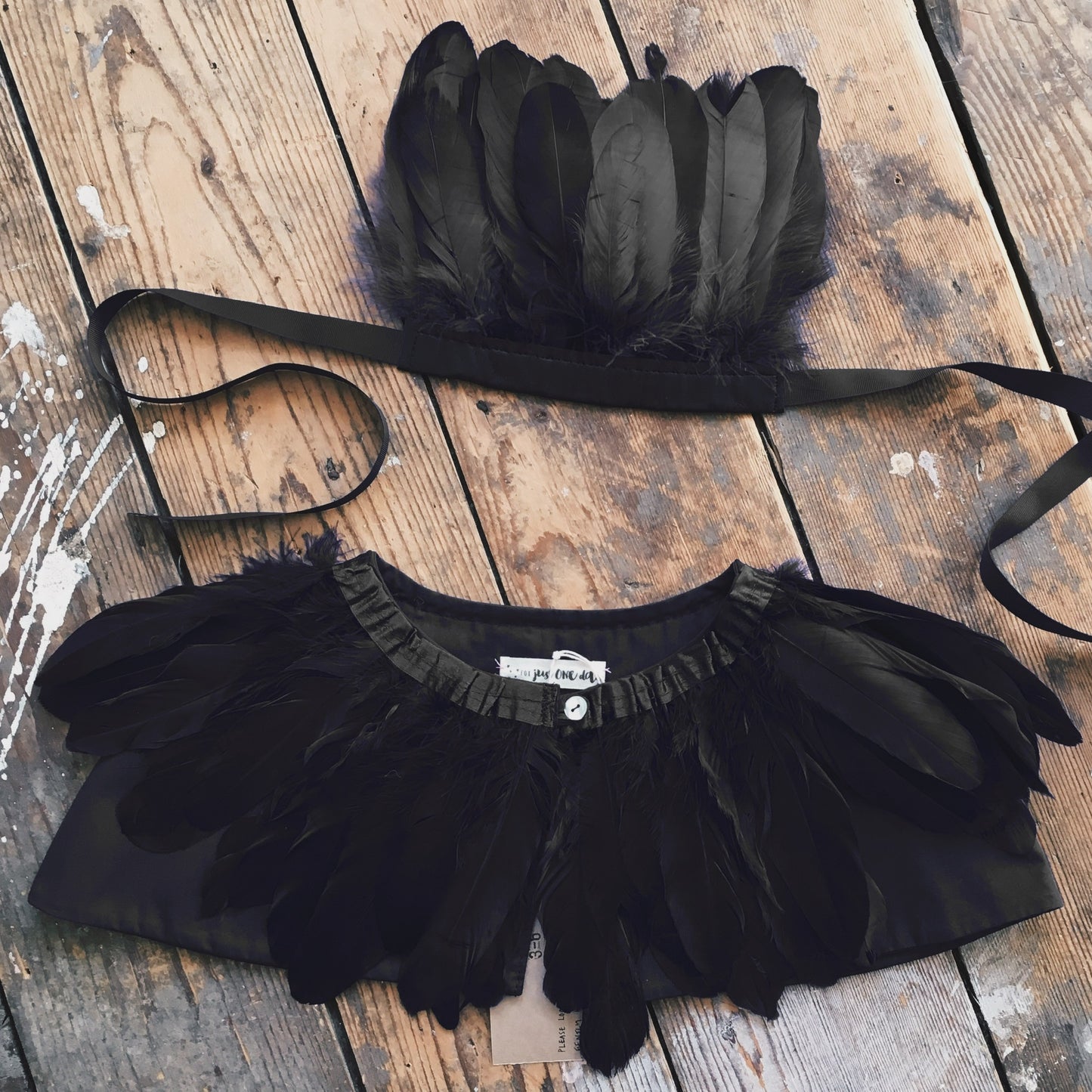 flat-lay raven black feather headdress and feather cape by For Just ONE Day