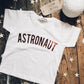 flat-lay on wooden floorboards of astronaut t-shirt in copper by For Just ONE Day