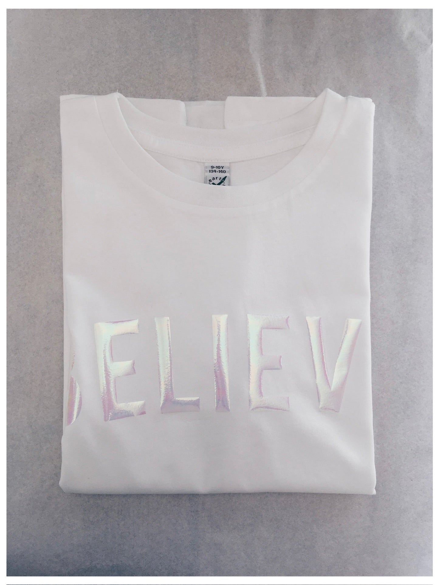 Iridescent Pearl print on folded white Believe t-shirt by For Just ONE Day