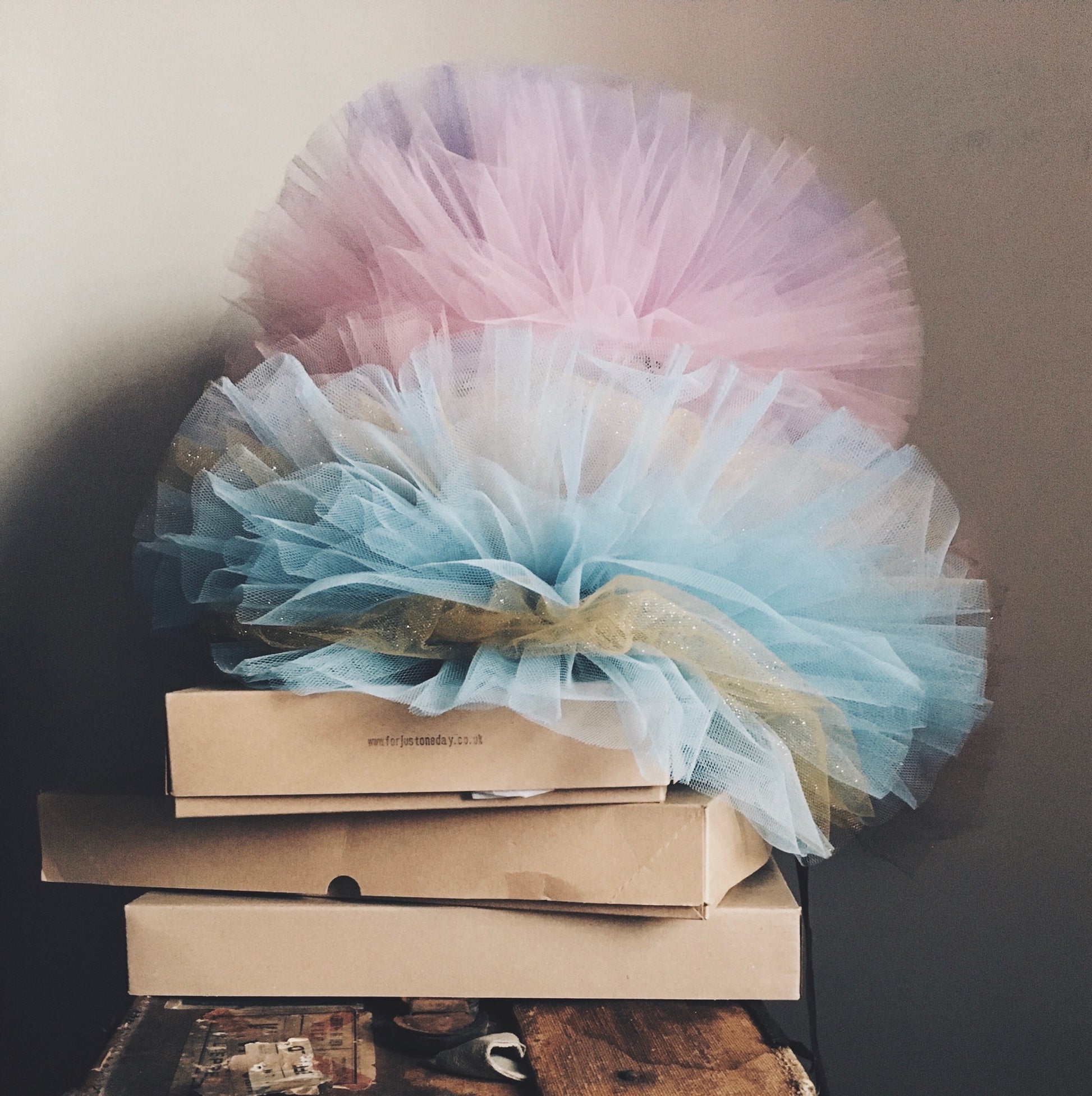 A pile of airy Tulle clown collars on brown packaging boxes