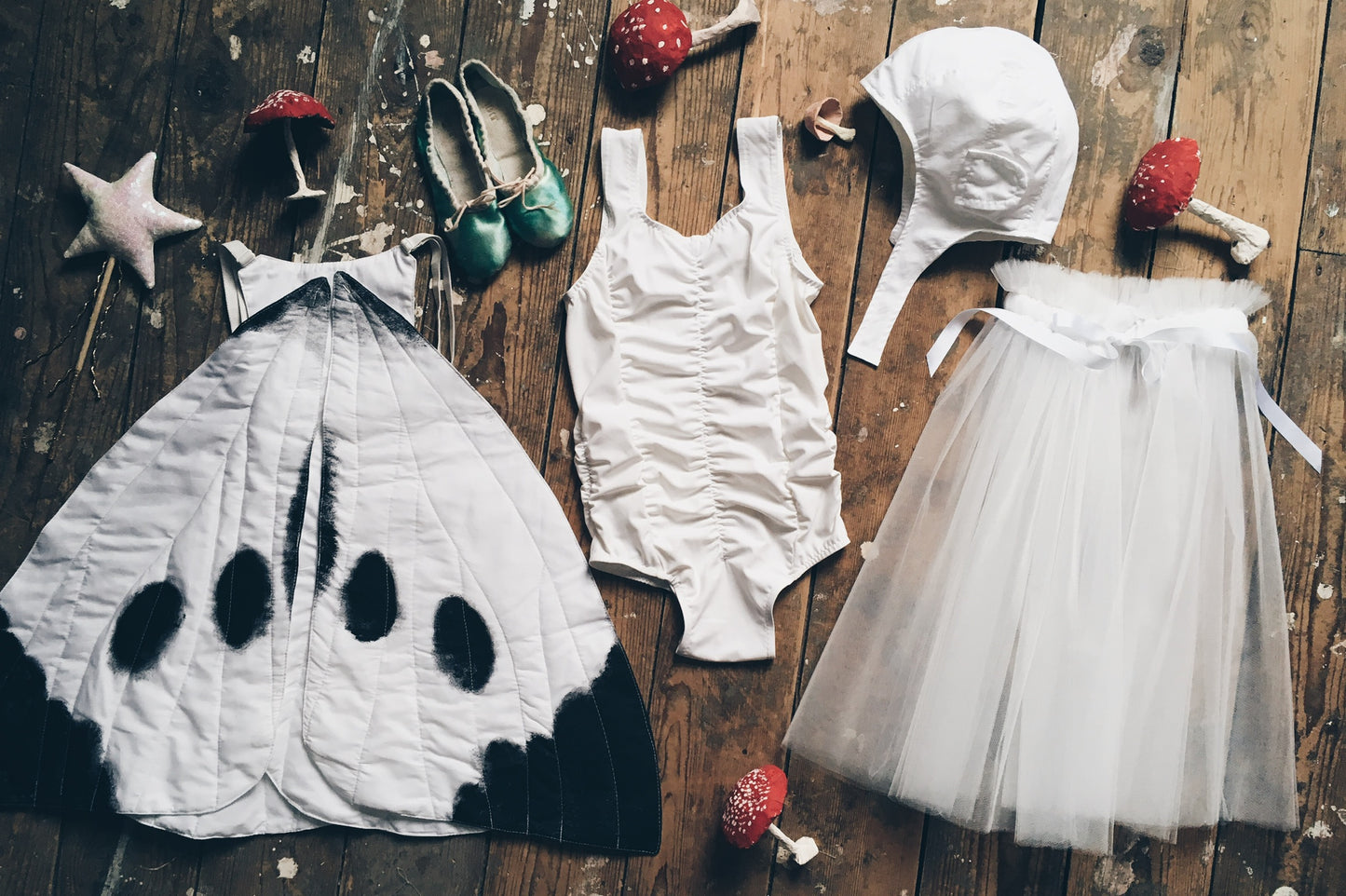flat lay of a Childs Flower fairies costume on wooden floorboards