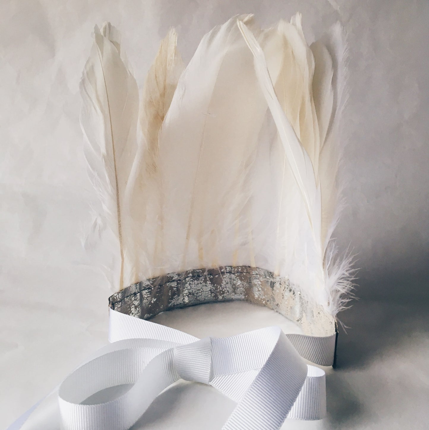 back view of white feather and metallic leather headdress by For Just ONE Day