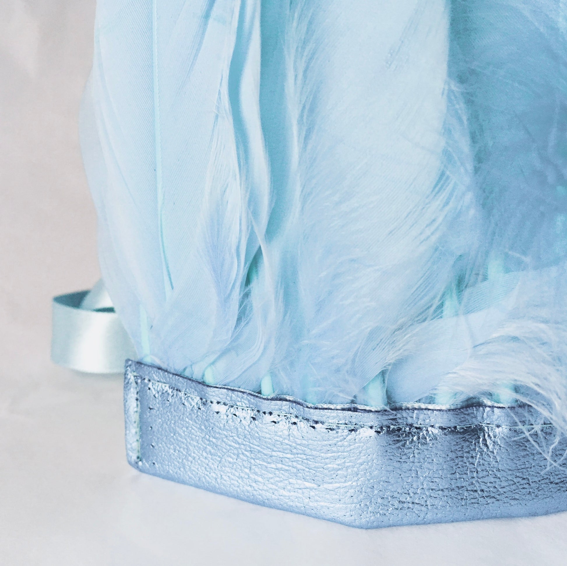 close up of Pastel blue feather and leather headdress by For Just ONE Day